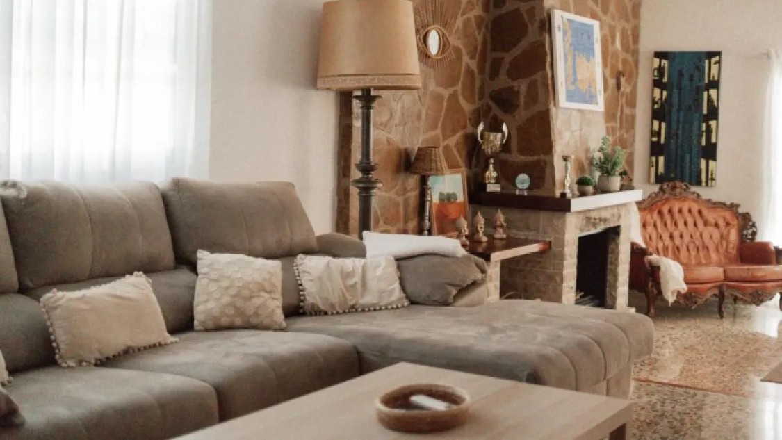Villa lounge with a large corner sofa and stone fireplace