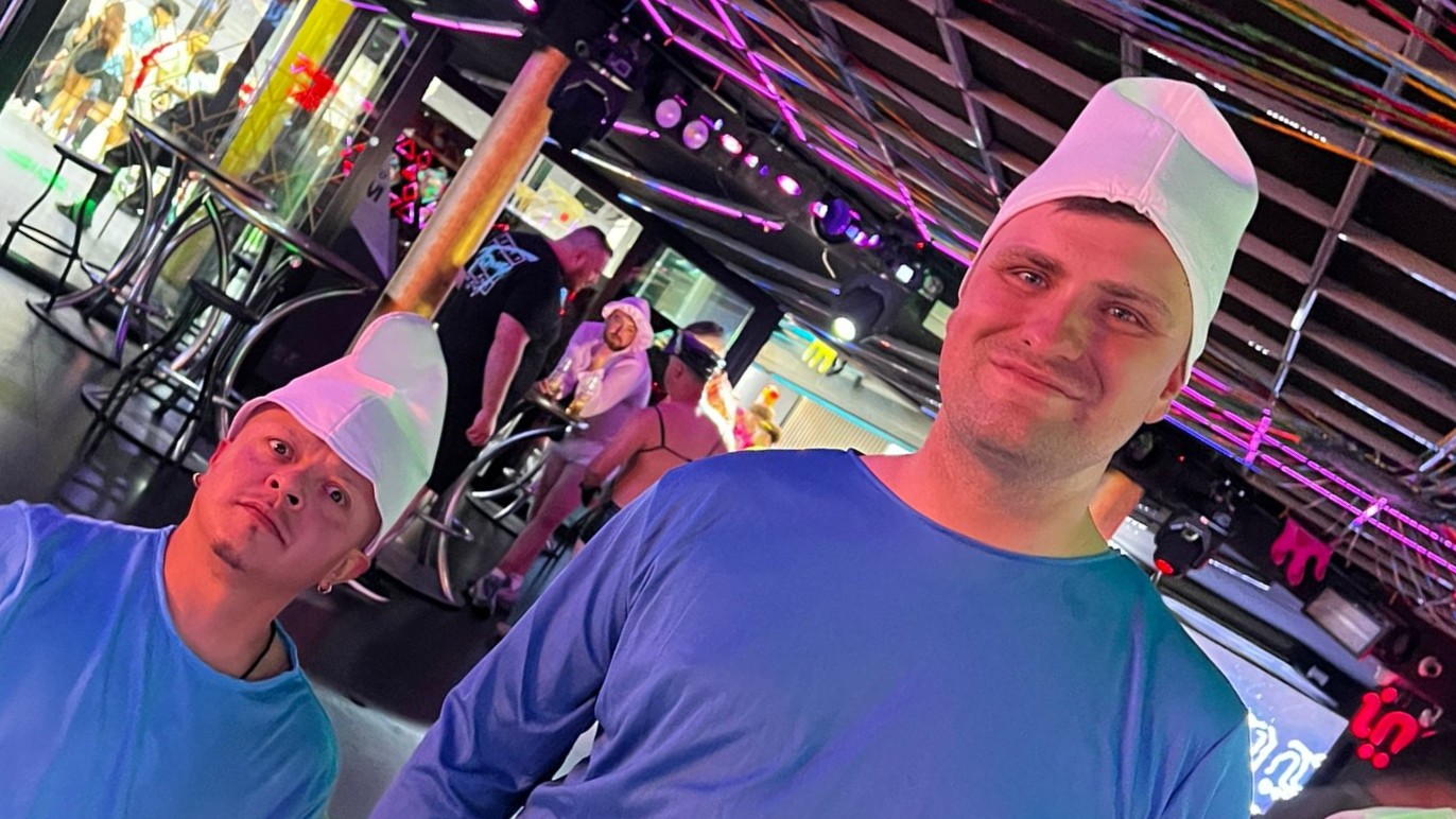Stag handcuffed to Smurf costume dwarf entertainer in Benidorm