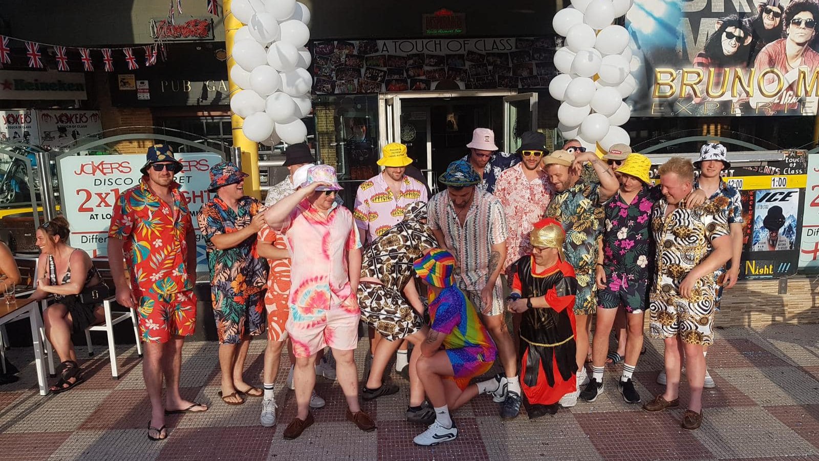 Stag group in fancy dress enjoying Benidorm nightlife during fiestas