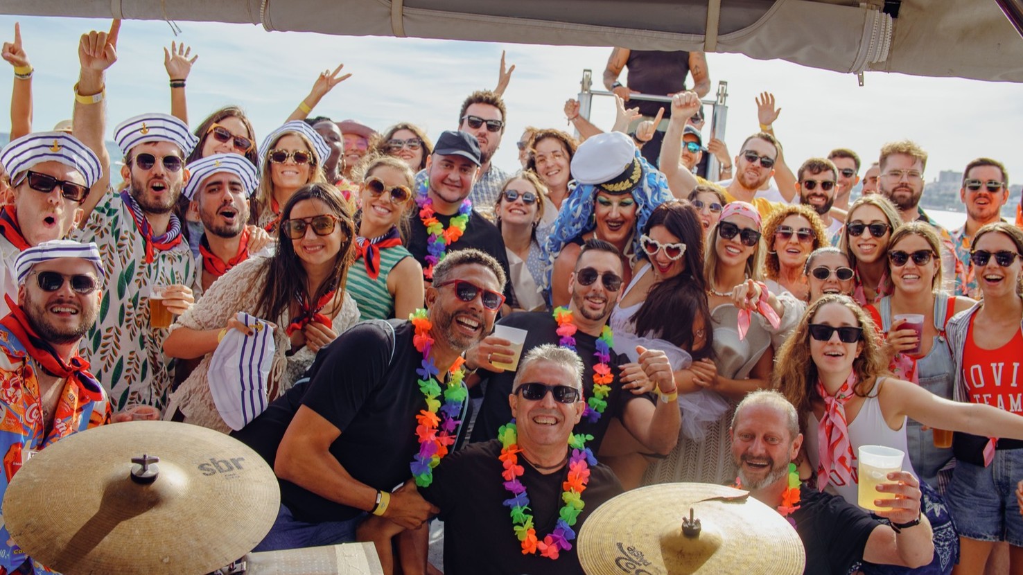 Large group celebrating on a party boat in Benalmadena during a sunny hen and stag weekend boat party