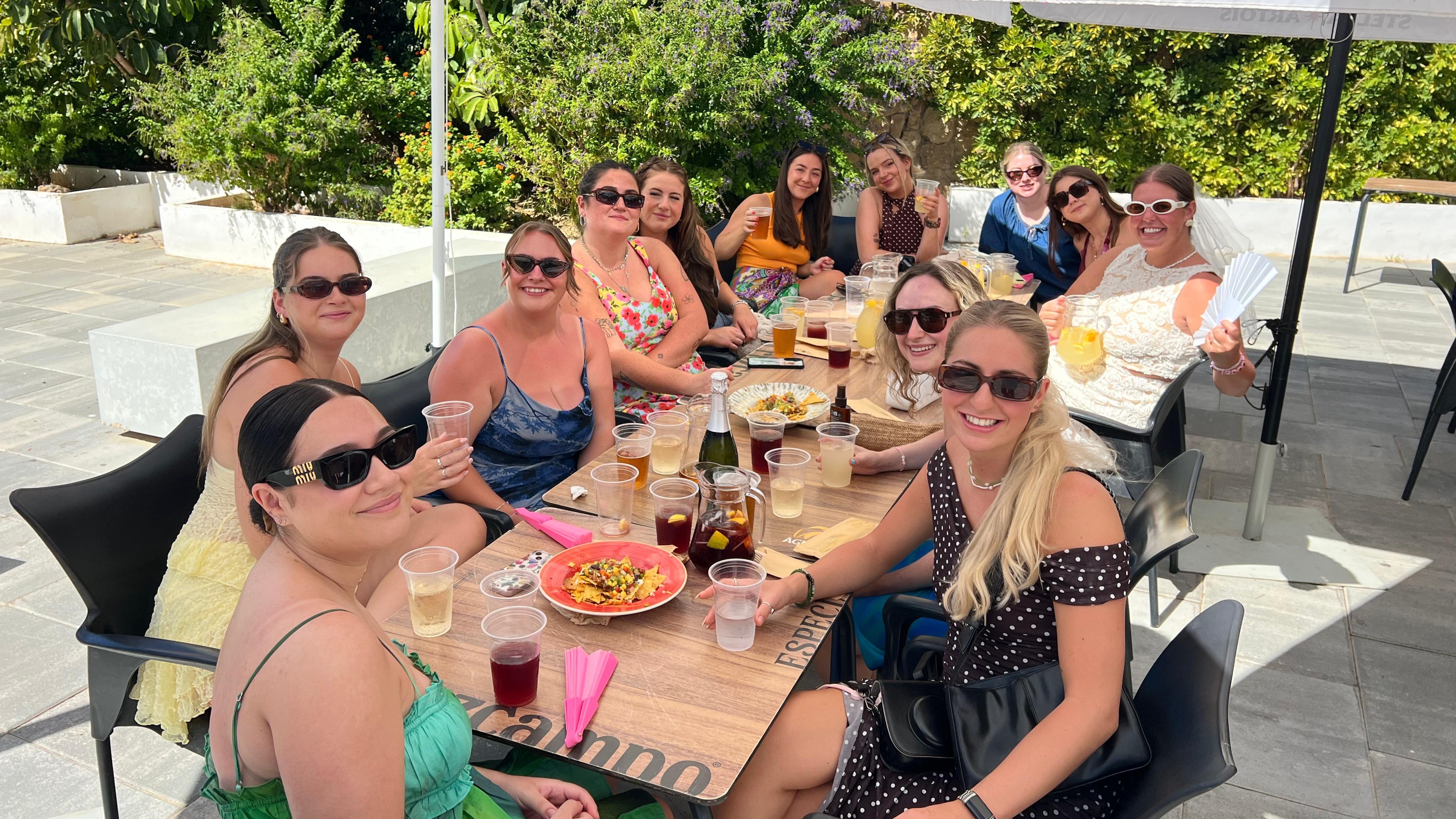 Group enjoying bottomless brunch with cava and sea views at Oasis Beach Benidorm