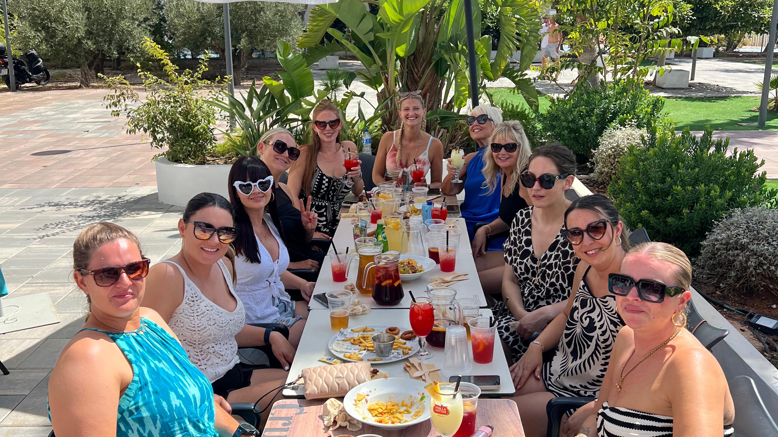 hen party group relaxing at beachfront brunch venue in Benidorm